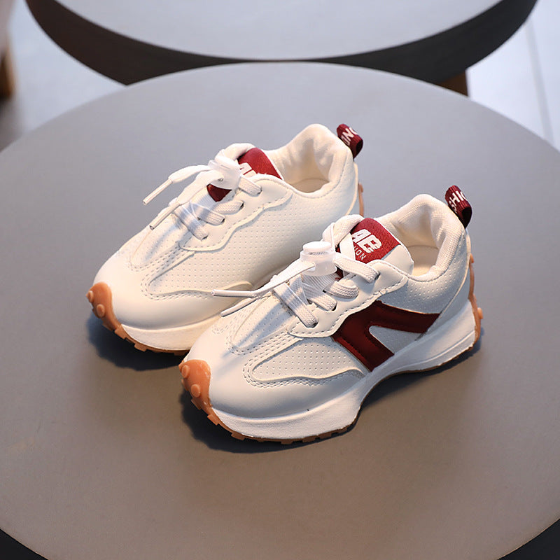 A boy in breathable white sneakers for children