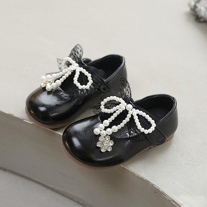 Sweet bow-adorned little leather shoes