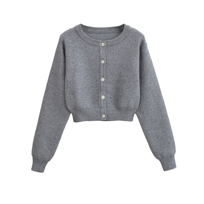 Korte vest met ronde hals lange mouwen en knopen