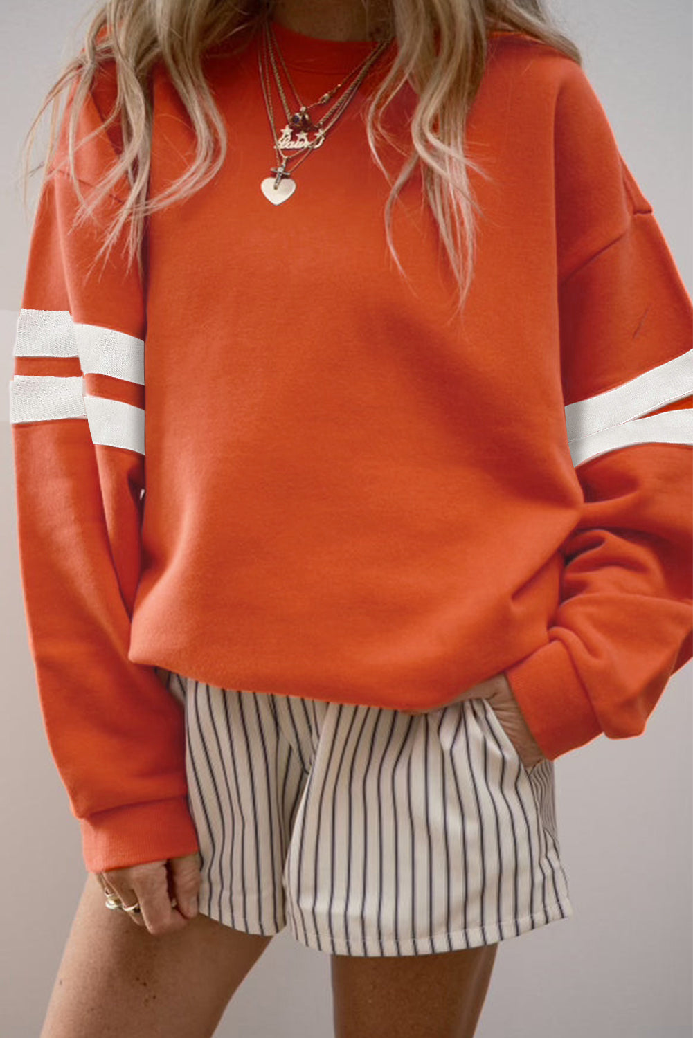Preppy sweatshirt met strepen op de mouwen en een losse pasvorm