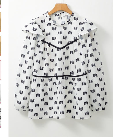 Witte blouse met bies strikprint en ronde hals