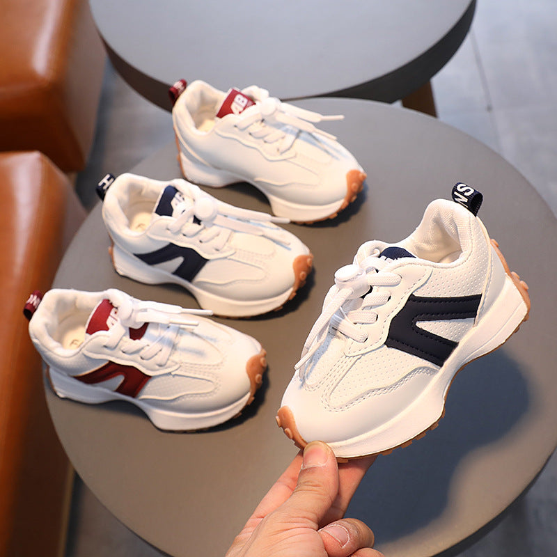 A boy in breathable white sneakers for children