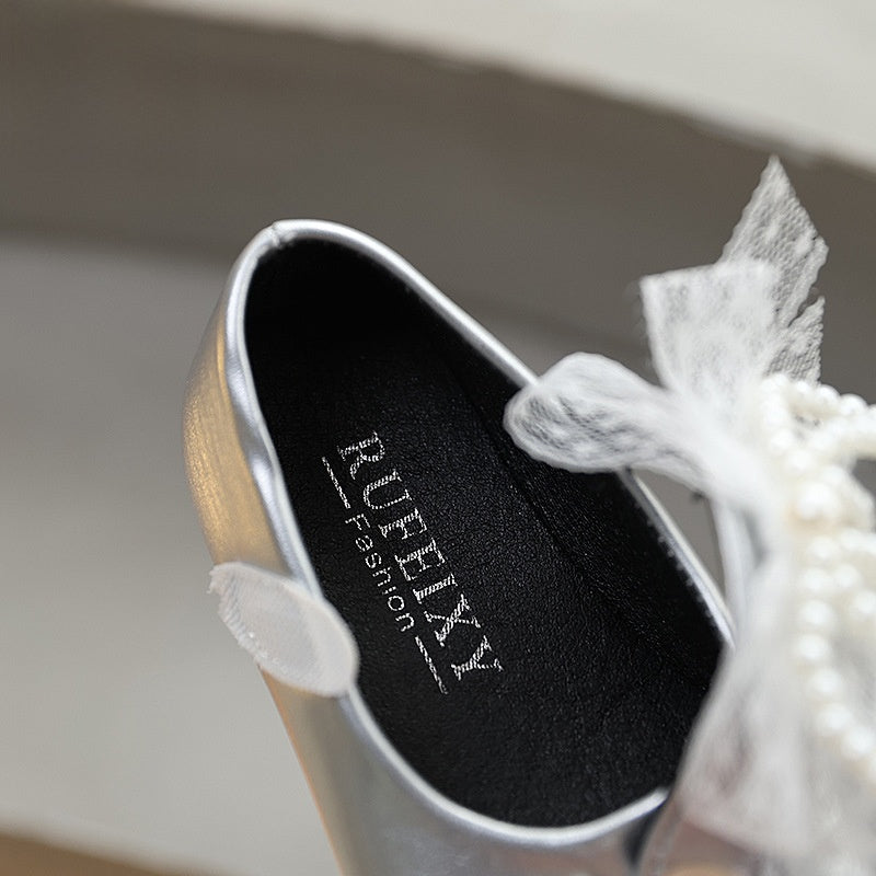 Sweet bow-adorned little leather shoes