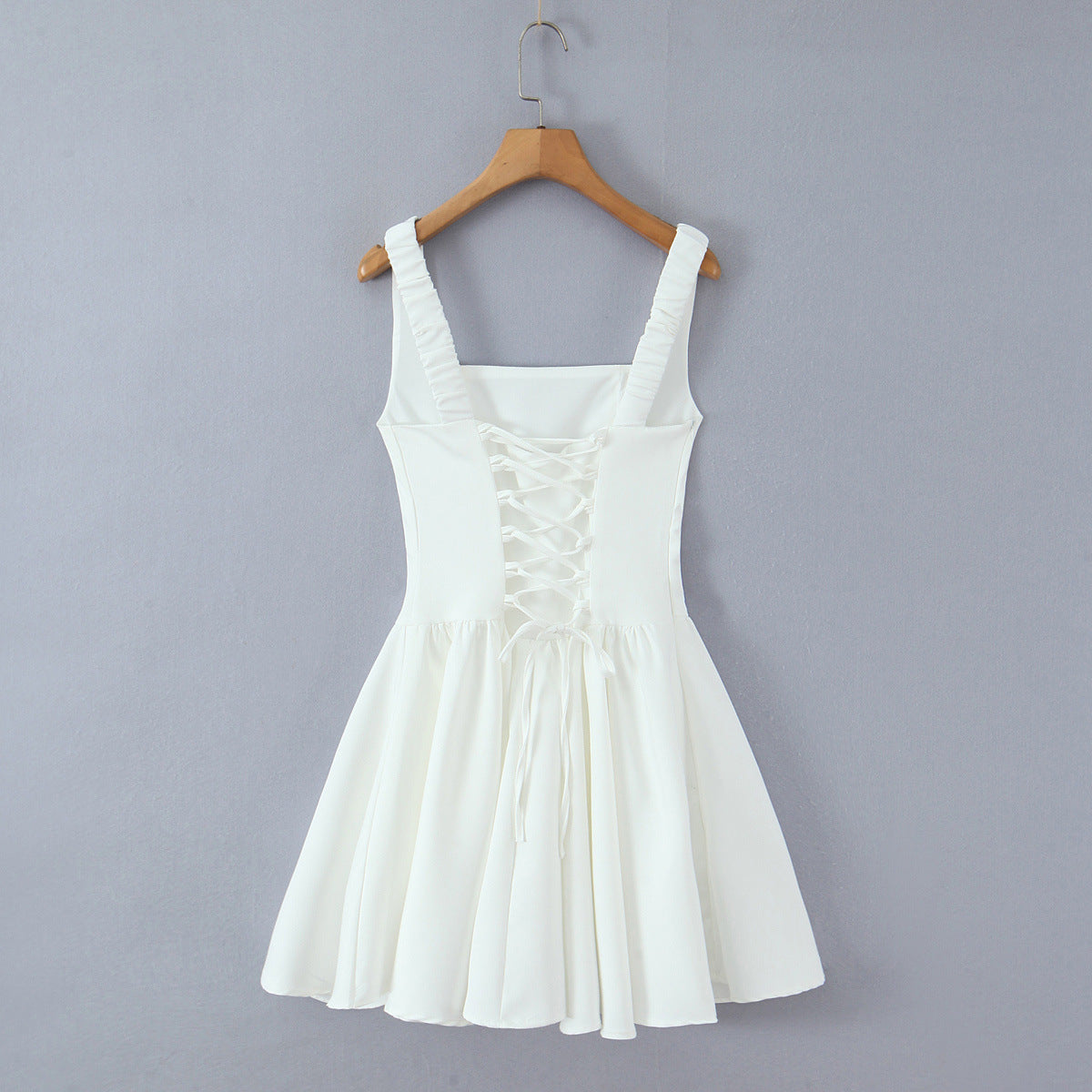 Spicy girl with shoulder straps and pleated dress