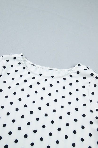 Witte top met lange mouwen en stippenprint en sla-afwerking