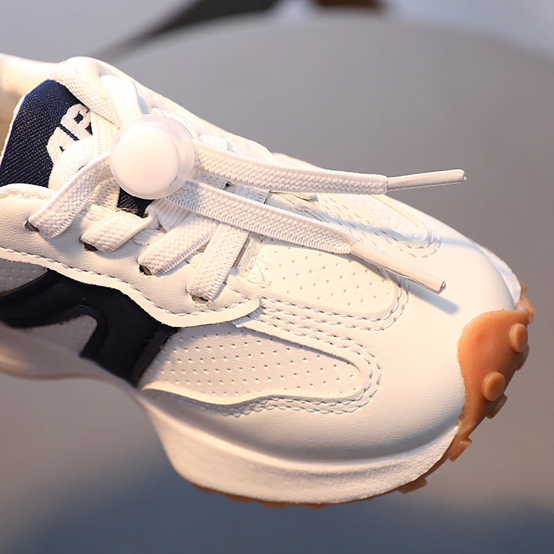 A boy in breathable white sneakers for children