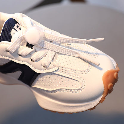A boy in breathable white sneakers for children