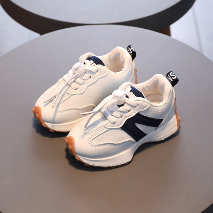 A boy in breathable white sneakers for children