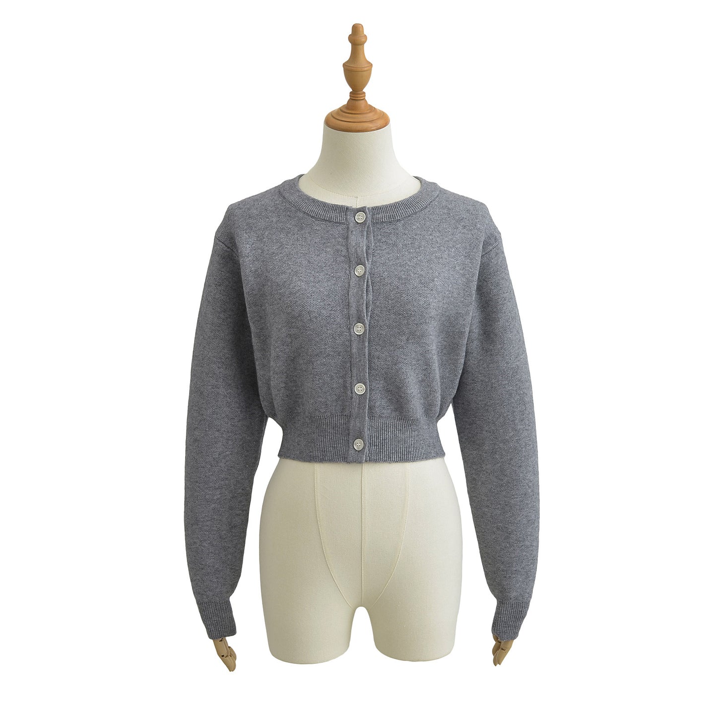 Korte vest met ronde hals lange mouwen en knopen