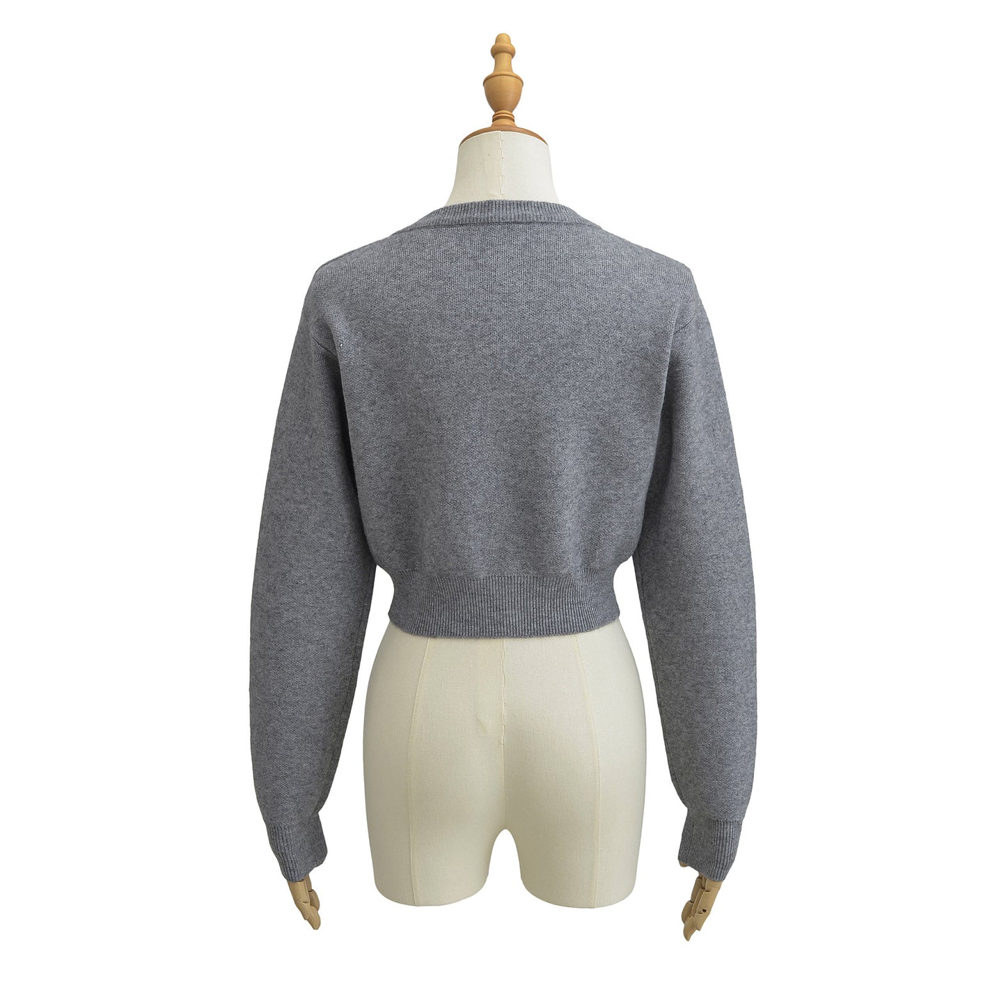 Korte vest met ronde hals lange mouwen en knopen
