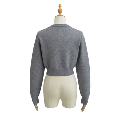 Korte vest met ronde hals lange mouwen en knopen