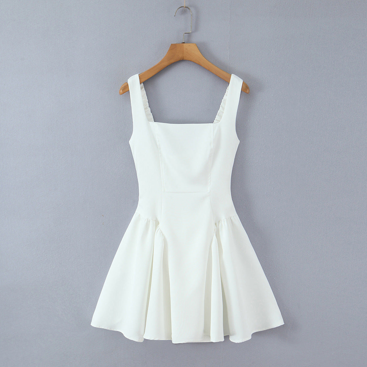 Spicy girl with shoulder straps and pleated dress
