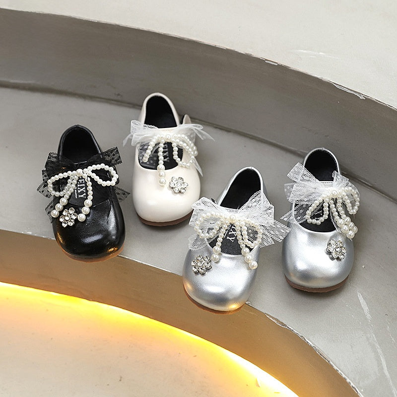 Sweet bow-adorned little leather shoes