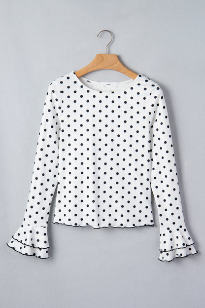Witte top met lange mouwen en stippenprint en sla-afwerking