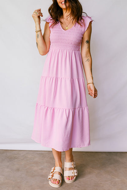Roze midi-jurk met geplooide top wijd uitlopende mouwen en ruches